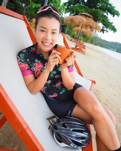 Asian cyclist girl on the beach